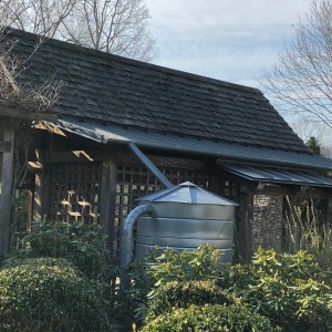 Cistern attached to gutters on a garden building