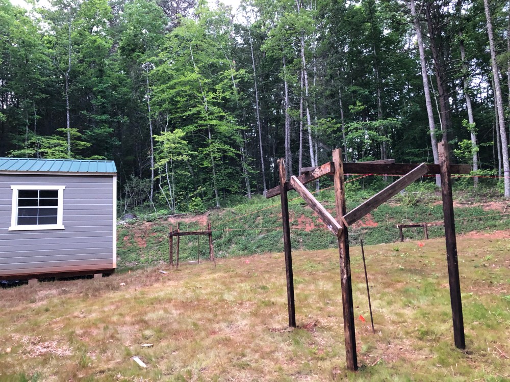 Wooden scaffolding and string for laying out yurt deck.