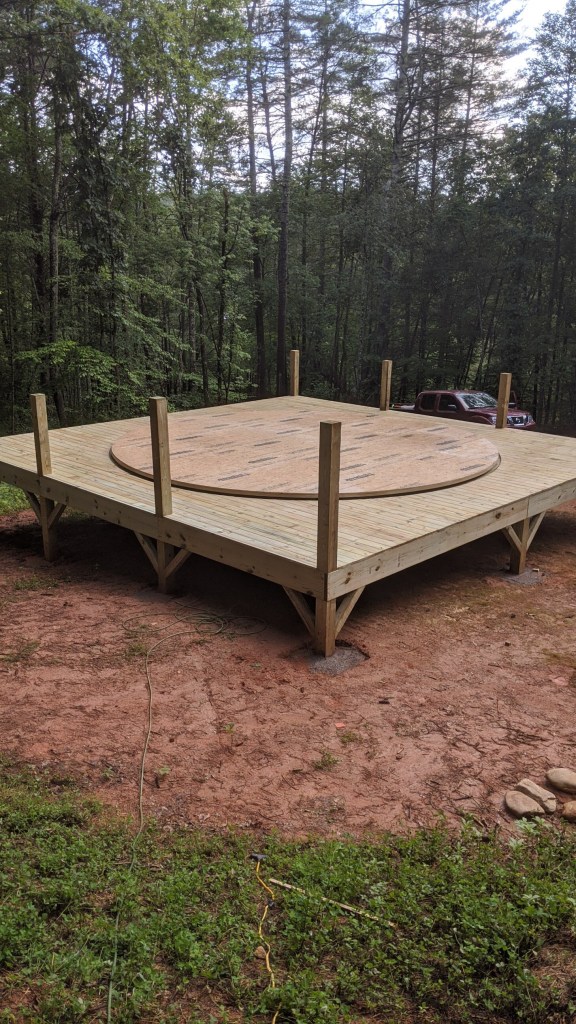 Yurt deck with round platform in center waiting for handrails